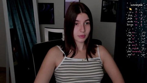 Brunette webcam girl in tight striped tank top teasing with cleavage