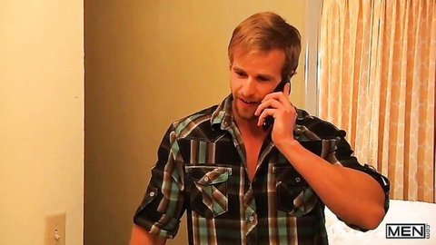 Muscular blonde guy in open plaid shirt talking on phone