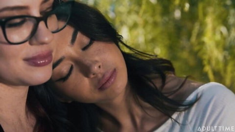 Chloe Surreal and Jessica Ryan in steamy intimate embrace with glasses