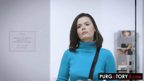 Dharma Jones in blue turtleneck, seductive gaze in office scene
