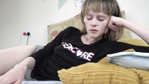 Sydney Harwin lounging casually in t-shirt and shorts on bed