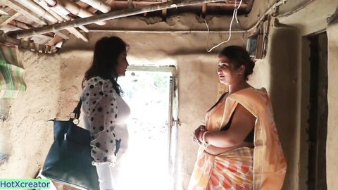 Desi women in saree and blouse chatting intimately in village