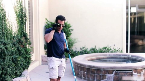 Handsome pool boy in uniform by the pool with Natasha White