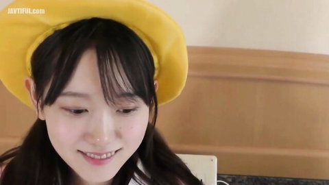 Smiling Asian girl in yellow beret, teasing vibe