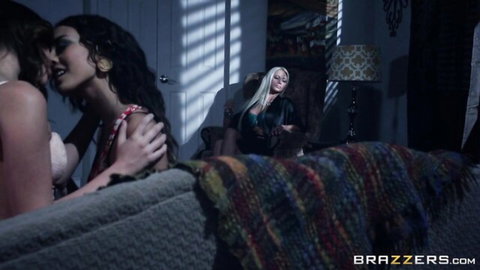 Nikita Von James watches two busty brunettes kiss passionately in hot lesbian scene