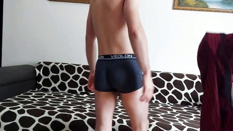 Shirtless twink in tight blue underwear showing firm bubble butt from behind