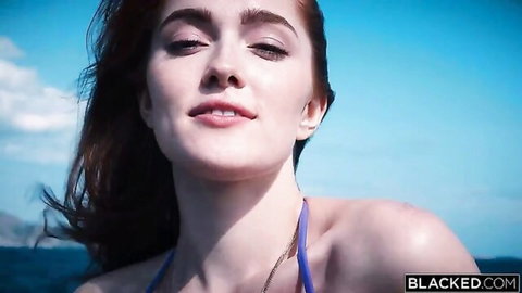 Jia Lissa redhead in blue bikini smiles seductively outdoors by sea