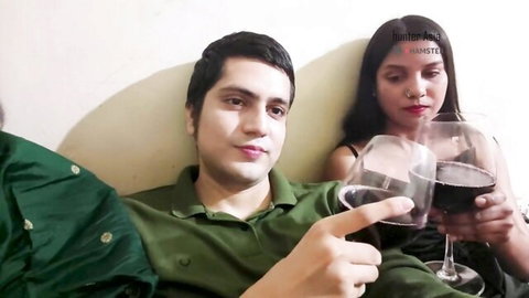 Indian couple toasting wine glasses in casual setup before steamy threesome