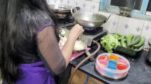 Mumbai Ashu in sheer top and apron, cooking in Indian kitchen