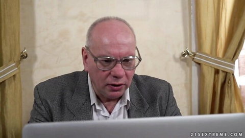 Old man in suit at desk in Anya Krey's hardcore old-young pounding scene