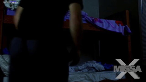 Creepy man in black sneaks up to purple bunk bed with clothes on floor in dark taboo bedroom