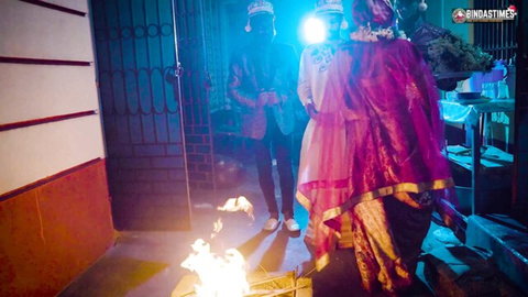 Desi Indian couple in wedding attire by sacred fire, teasing gangbang vibe