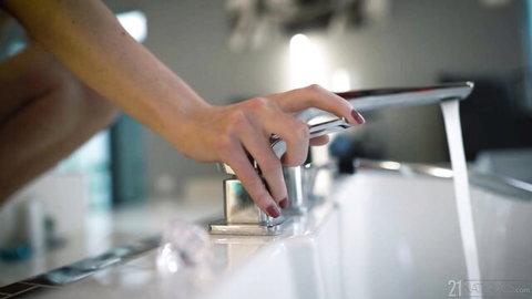 Stefany Kyler nude in erotic bathroom tease, hand on faucet