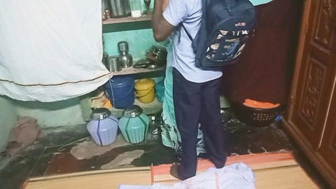 Indian man in casual clothes standing in home kitchen, teasing Tamil teacher student encounter
