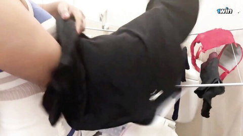 Sexy Sri Lankan MILF in sheer top hangs red panties and black pants on bathroom rack