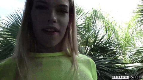 Blonde Leah Lee in neon green top teases outdoors for interracial action with Jax Slayher