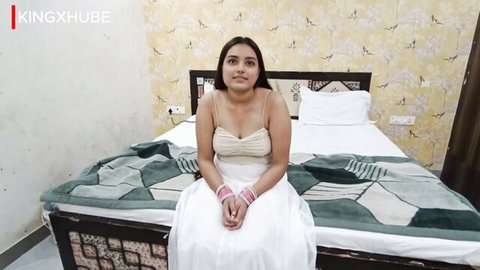 Ayushi Bhabhi in white camisole dress, sitting seductively on bed, Indian beauty