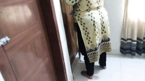Curvy South Asian woman in tight salwar kameez bending over by door showing big ass