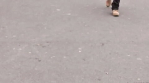 Lea Lexis walking in tight tan pants on urban street, teasing view