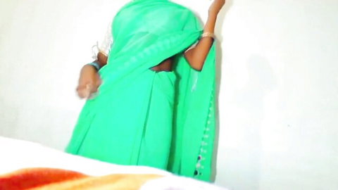 Veiled Indian Bhabhi in green sari teasing in guest room