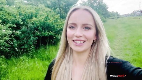 Smiling blonde woman outdoors in sweater, teasing POV intro to deepthroat massive cock