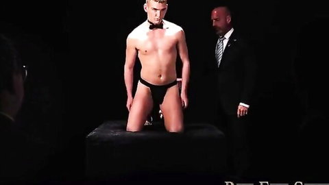 Blonde twink in bowtie kneels submissively for suited master domination