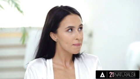 Brunette beauty with small tits teasing in open white silk robe showing deep cleavage