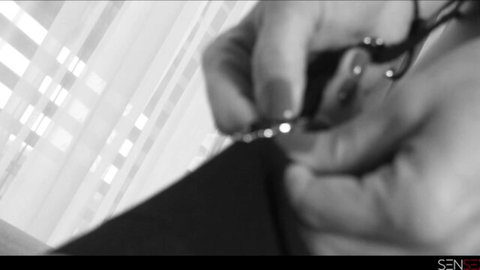Little Caprice adjusting necklace on her dark dress, teasing close-up