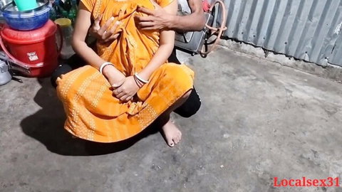 Man gropes Indian woman's tits over yellow saree in outdoor apartment