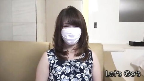 Japanese babe in floral tank top and white mask sitting on couch teasing viewers