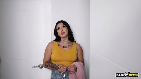 Diamond Franco in yellow tank top and jeans, tattooed Latina beauty