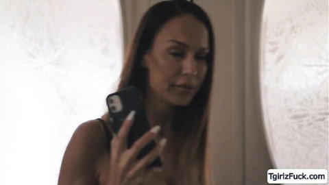 McKenzie Lee taking mirror selfie in black lingerie top
