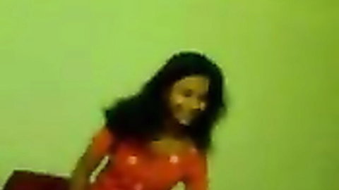 Busty Indian teen smiling in orange top, ready for first blowjob experience