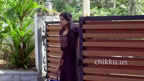 Sexy Indian brunette babe in tight purple dress walking through outdoor gate