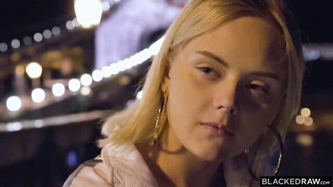 Blonde Emily Cutie in light jacket on nighttime bridge