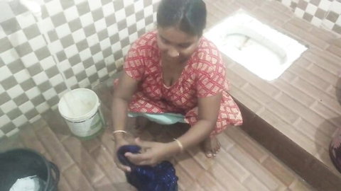 Indian aunty squatting in red dress, washing in desi naughty scene