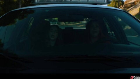 Two sexy brunettes in police car front seats teasing through windshield
