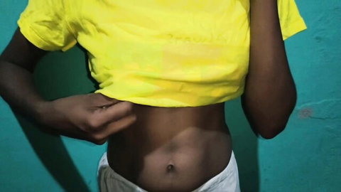 Sexy South Asian babe lifting yellow t-shirt exposing toned abs and navel