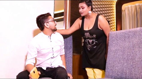 Sensual Indian teacher in tank top leans over student for intimate moment
