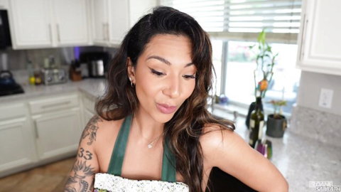 Sloansmoans teases as mommy in green apron, playful pout close-up