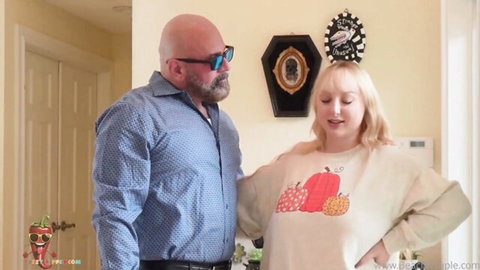 Skylar Vox in pumpkin sweater with partner, smiling on Thanksgiving