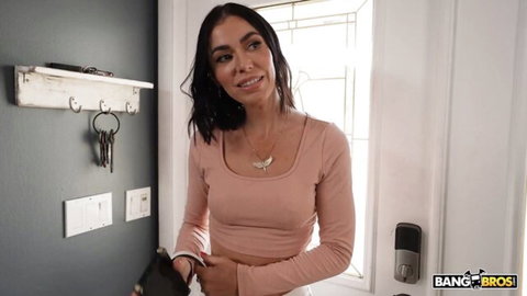 Venus Valencia in seductive pink crop top at door, teasing smile