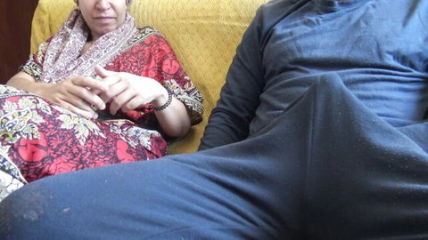 Turkish MILF in traditional dress sits with man showing massive bulge