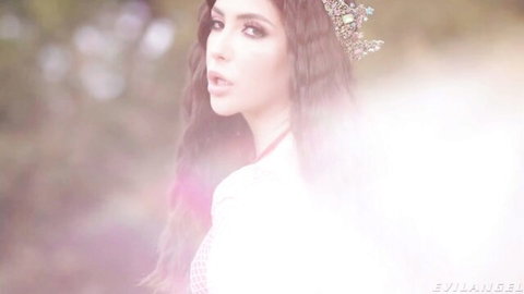 Jane Wilde in sparkling crown and white lace top, mystical forest gaze