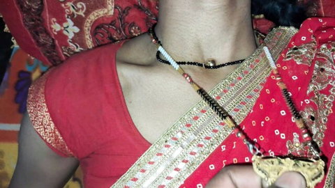 Sexy Indian housewife in red saree flaunting mangalsutra necklace and cleavage