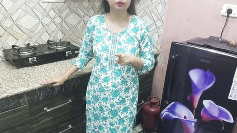 Indian stepmom in floral green dress poses seductively in kitchen