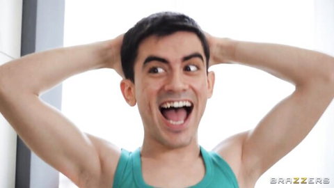 Ecstatic muscular brunette hunk smiling with hands behind head in teal tank top