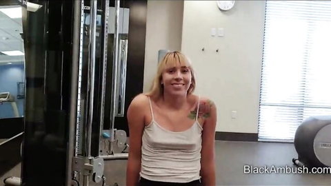 Smiling blonde teen in tight white tank top posing in gym for BBC ambush