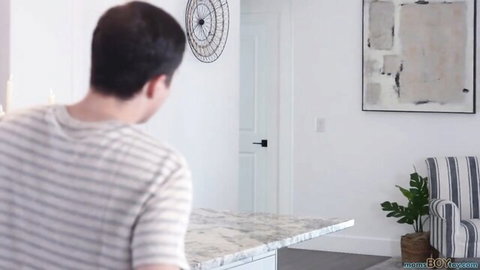 Man in striped shirt in kitchen, setup for Melissa Stratton's big tits pounding scene