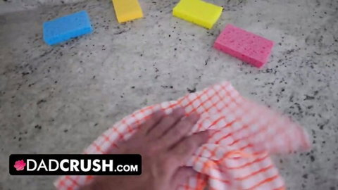 Hand wiping colorful sponges on counter in Dad Crush teaser scene